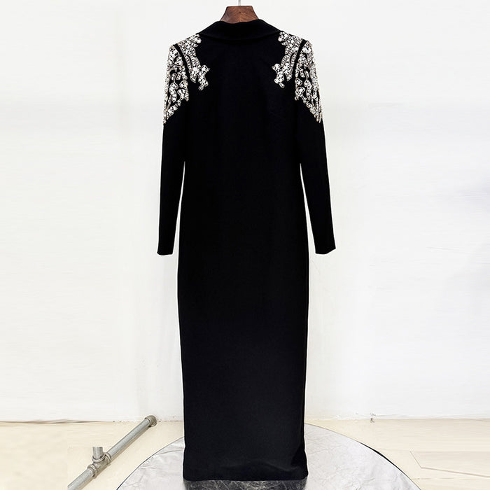Black dress with white embroidery on sleeves and neckline on a mannequin against a white background.