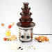 Stainless steel chocolate fountain on a white background