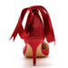 Red high-heeled shoe with a large bow on a white background