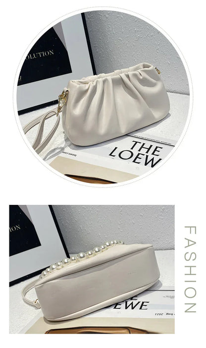 White handbag with pearl details on a magazine background, featuring the brand 'The Loew'.