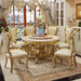 Luxurious dining room with gold table and chairs in a well-decorated room.