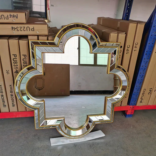 Decorative mirror with gold frame in a warehouse setting