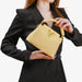 Woman holding a gold handbag with a white background
