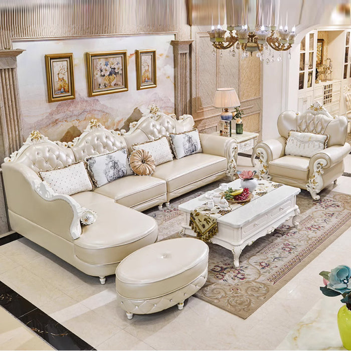 Luxurious living room with cream-colored sofa, ottoman, and coffee table.