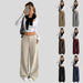 Woman wearing a white top and beige wide-leg pants with multiple color options displayed.