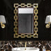 Decorative mirror with gold frame in a bathroom setting
