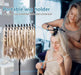 Portable wig holder with a woman using it to style another woman's hair.