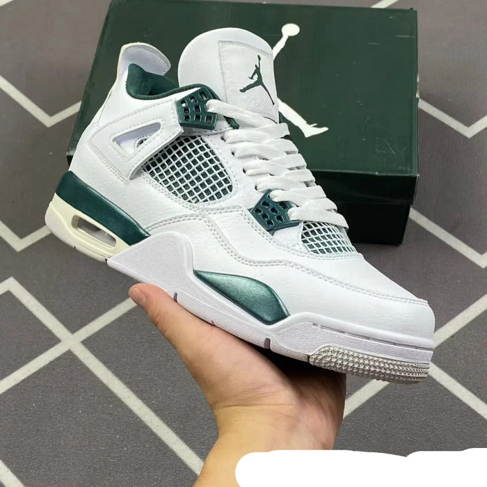 White and green sneaker held in a hand with a blurred background