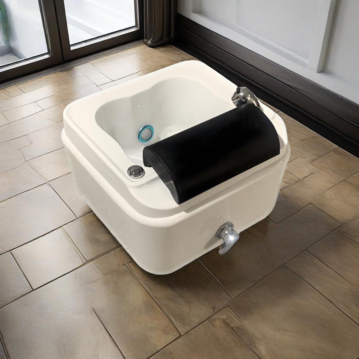 White foot bath with black cover on a tiled floor