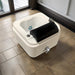 White foot bath with black cover on a tiled floor