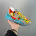 Colorful sneaker with transparent sole held against a gray background