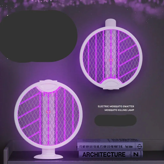 Electric mosquito swatter with purple light on a dark background