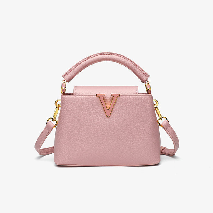 Pink handbag with gold accents on a white background