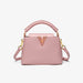 Pink handbag with gold accents on a white background