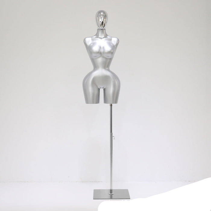 Silver mannequin on a stand against a white background