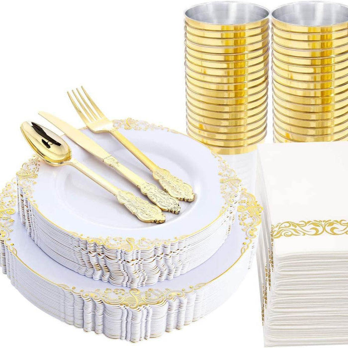 Gold and white party supplies including plates, cutlery, and cups on a white background