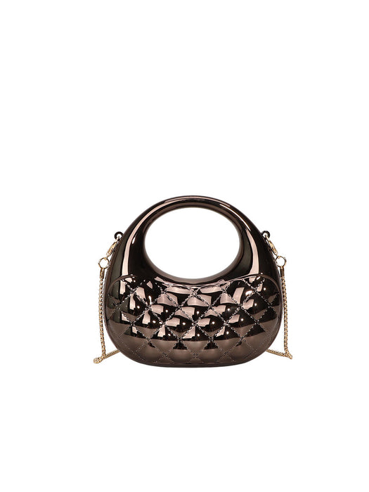 Bronze handbag with intricate design on a white background