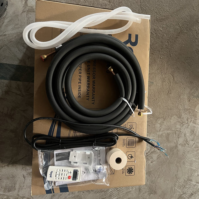 Unboxed electronic components including a black cable, white tube, and remote control on a cardboard box.