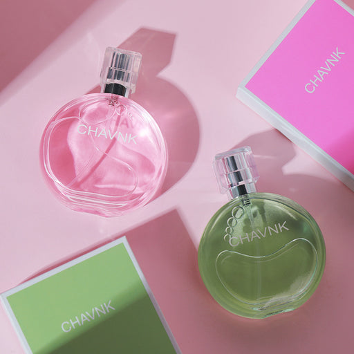 Two perfume bottles, one pink and one green, with 'CHAVNK' branding on a pink background.