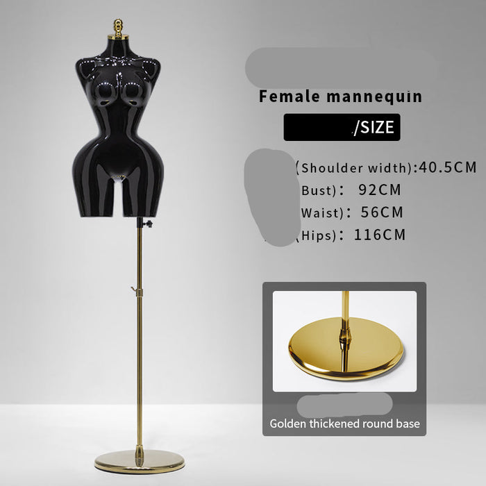 Black female mannequin with gold base on a gray background