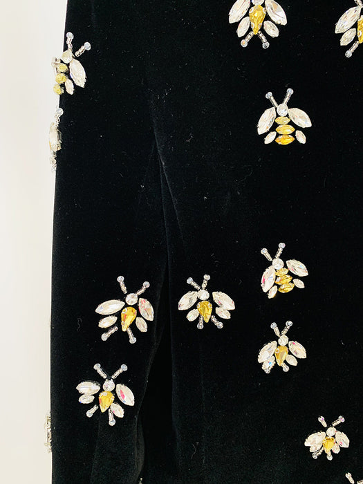 Black fabric with embroidered bee patterns on a white background