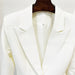 White blazer on a hanger against a white background