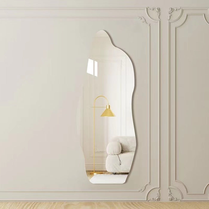 Decorative wall mirror on a wall with ornate molding