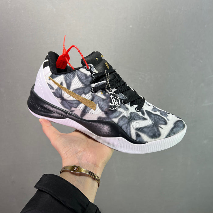 Basketball shoe with floral pattern and brand logo held by a hand against a gray background