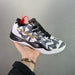 Basketball shoe with floral pattern and brand logo held by a hand against a gray background