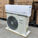 Panasonic air conditioning unit on a pallet with cardboard boxes in the background