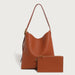 Brown leather handbag with matching pouch on a light gray background
