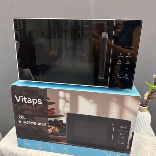 Black microwave oven on top of its packaging box with 'Vitaps' branding.