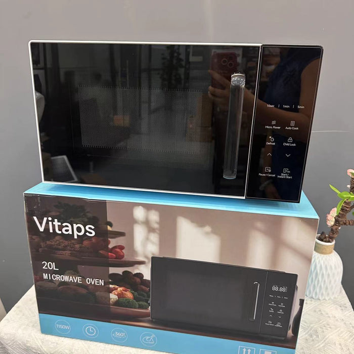 Black microwave oven on top of its packaging box with 'Vitaps' branding.