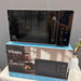 Black microwave oven on top of its packaging box with 'Vitaps' branding.