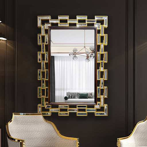 Decorative wall mirror with geometric frame on a dark wall