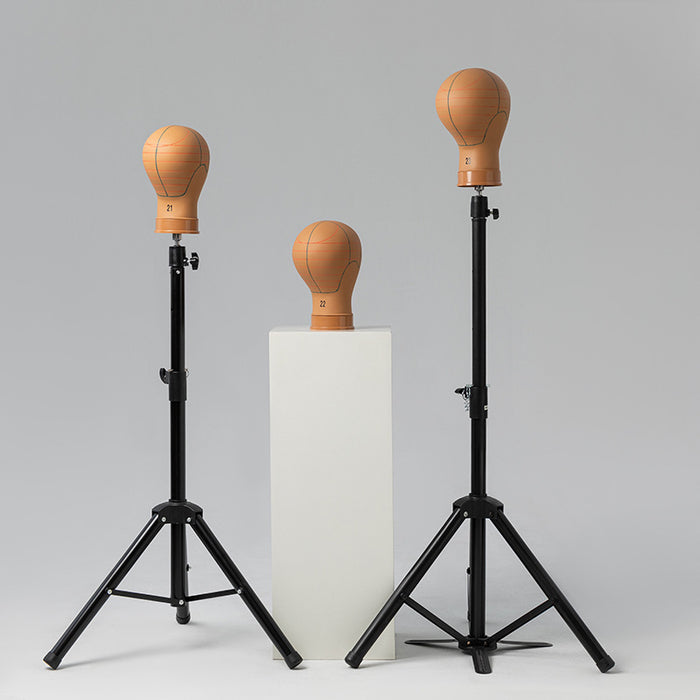 Two boxing speed bags on stands against a gray background