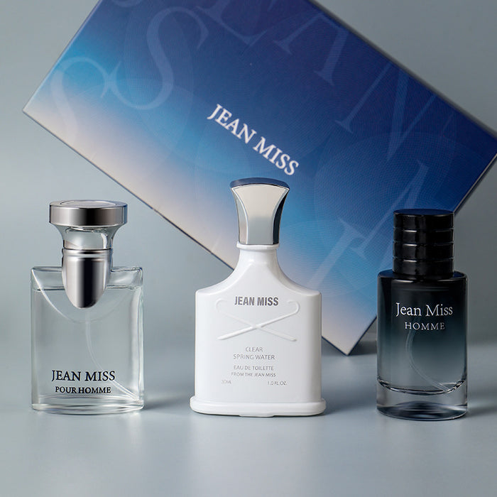 Three Jean Miss men's fragrances with a branded box in the background.