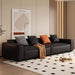 Modern black sofa with colorful cushions in a stylish living room.