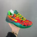 Colorful sneaker with red, green, and yellow design held against a gray background