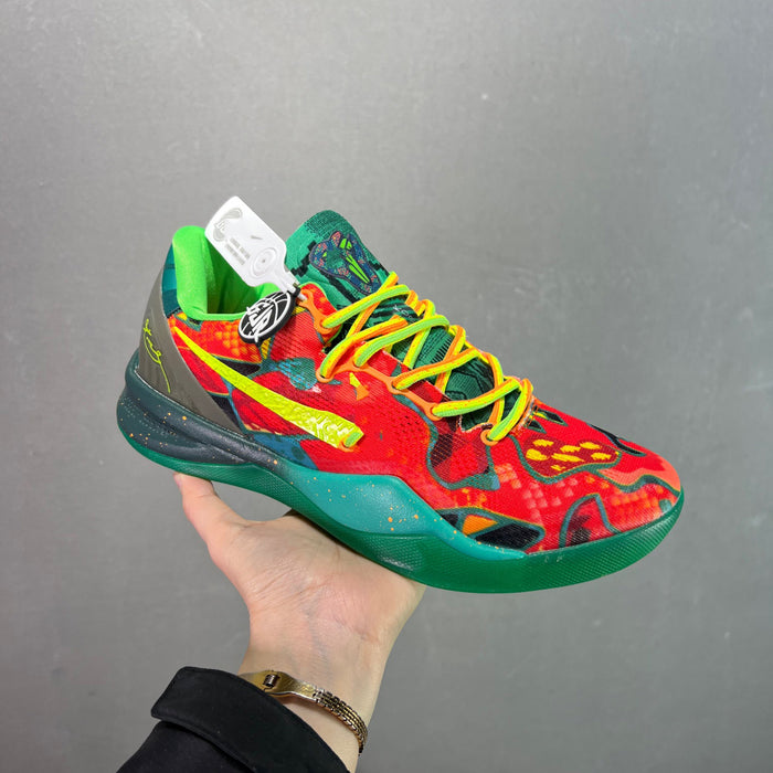 Colorful sneaker with red, green, and yellow design held against a gray background