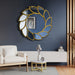 Decorative wall mirror with gold leaf design in a living room setting.