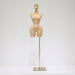 Mannequin torso on a stand with a gold head against a white background