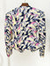 Colorful patterned shirt on a hanger against a white background
