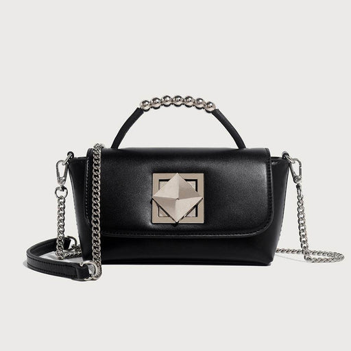 A black leather clutch bag with a chain shoulder strap, a lock-up cover, and a vertical square shape.