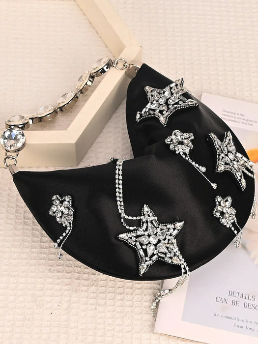 Black clutch bag with star-shaped embellishments on a light background
