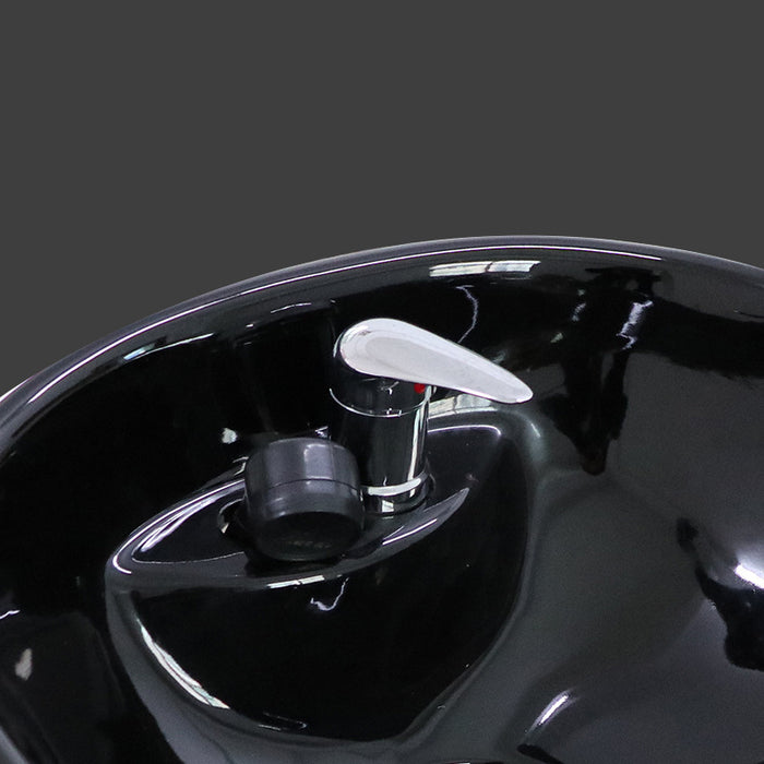 Close-up of a shiny black and silver car part on a dark background