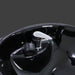 Close-up of a shiny black and silver car part on a dark background