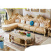 Luxurious gold and beige sofa set in a room with decorative elements.