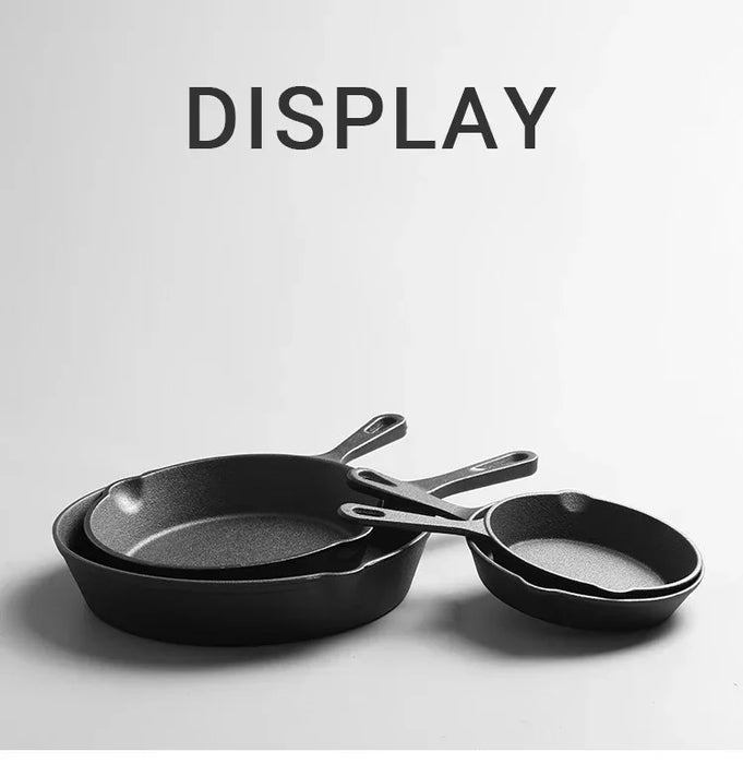 Set of black frying pans on a light gray background with 'DISPLAY' text above.