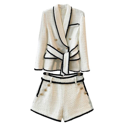 White blazer and shorts set with black trim on a white background